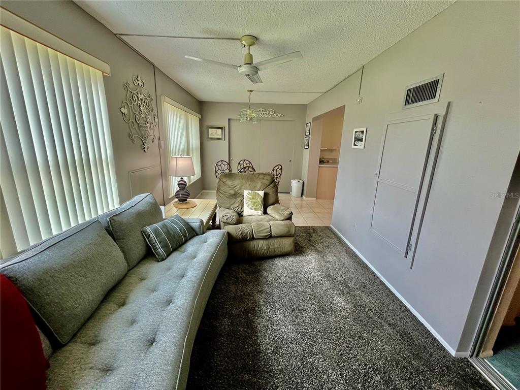 2403 Finlandia Lane, Unit 57 Clearwater, FL 33763 - Photo 12 of 41 a living room with furniture and a rug