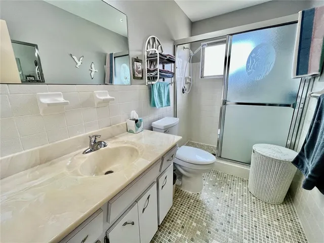 a bathroom with a sink toilet and shower