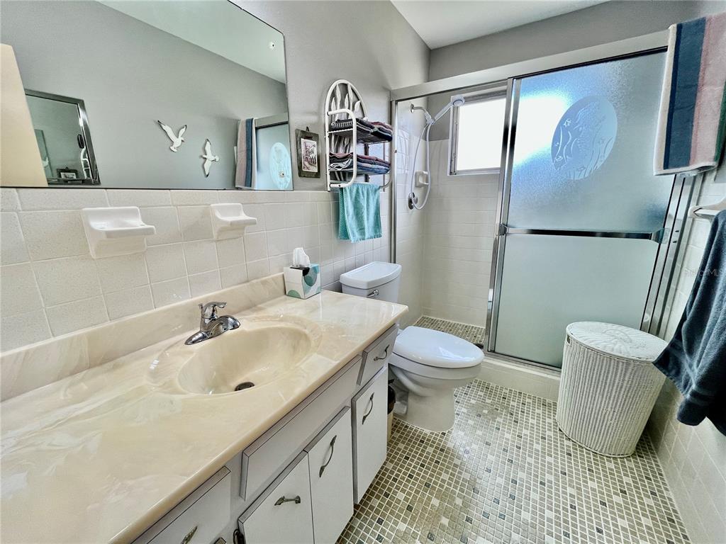 2403 Finlandia Lane, Unit 57 Clearwater, FL 33763 - Photo 15 of 41 a bathroom with a sink toilet and shower