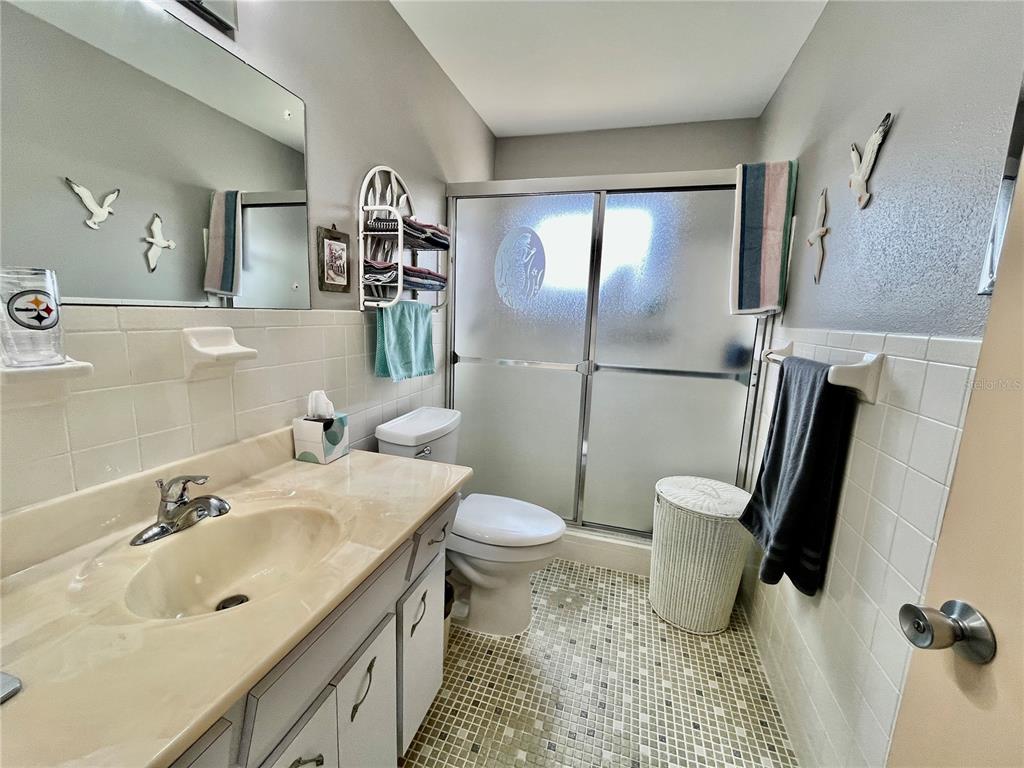 2403 Finlandia Lane, Unit 57 Clearwater, FL 33763 - Photo 16 of 41 a bathroom with a sink toilet and shower