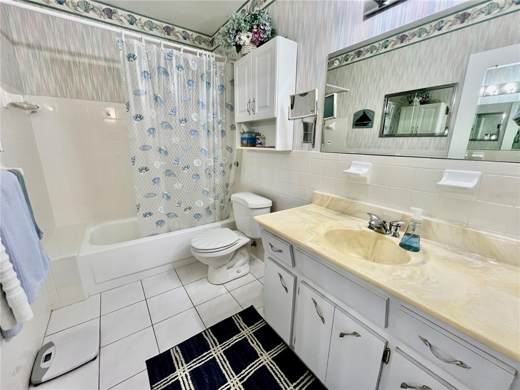 2403 Finlandia Lane, Unit 57 Clearwater, FL 33763 - Photo 17 of 41 a spacious bathroom with a double vanity sink mirror and toilet