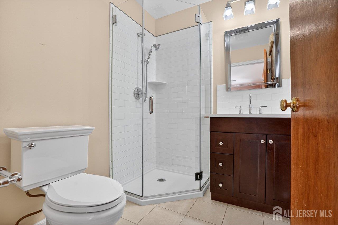 1 Wakefield Drive Edison, NJ 08820 - Photo 14 of 29 a bathroom with a toilet a sink and shower