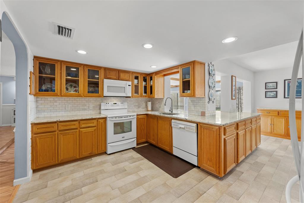 140 Valley Circle Brandon, FL 33510 - Photo 14 of 48 a large kitchen with stainless steel appliances granite countertop a stove and a sink