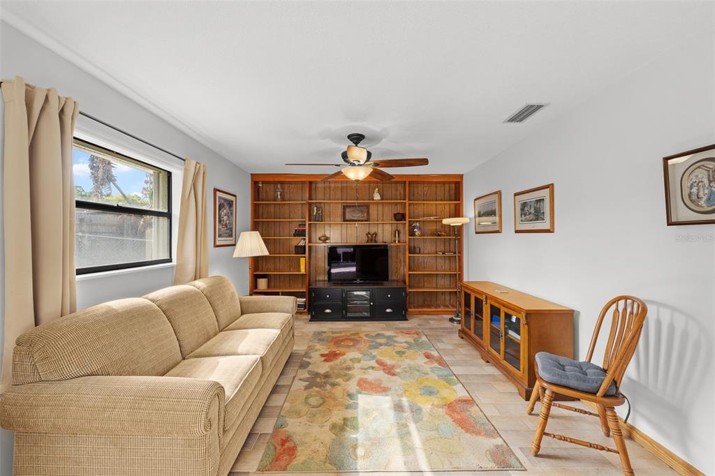 140 Valley Circle Brandon, FL 33510 - Photo 21 of 48 a living room with furniture a fireplace and a flat screen tv