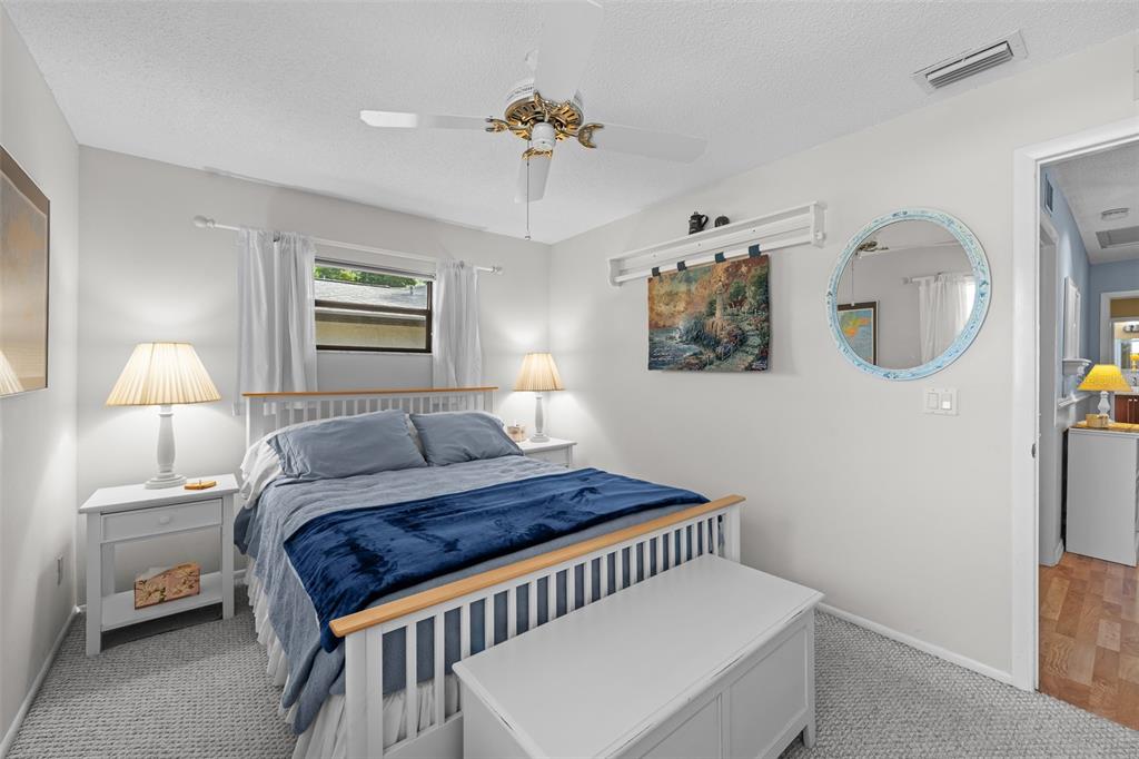 140 Valley Circle Brandon, FL 33510 - Photo 27 of 48 a bedroom with a bed and a chandelier