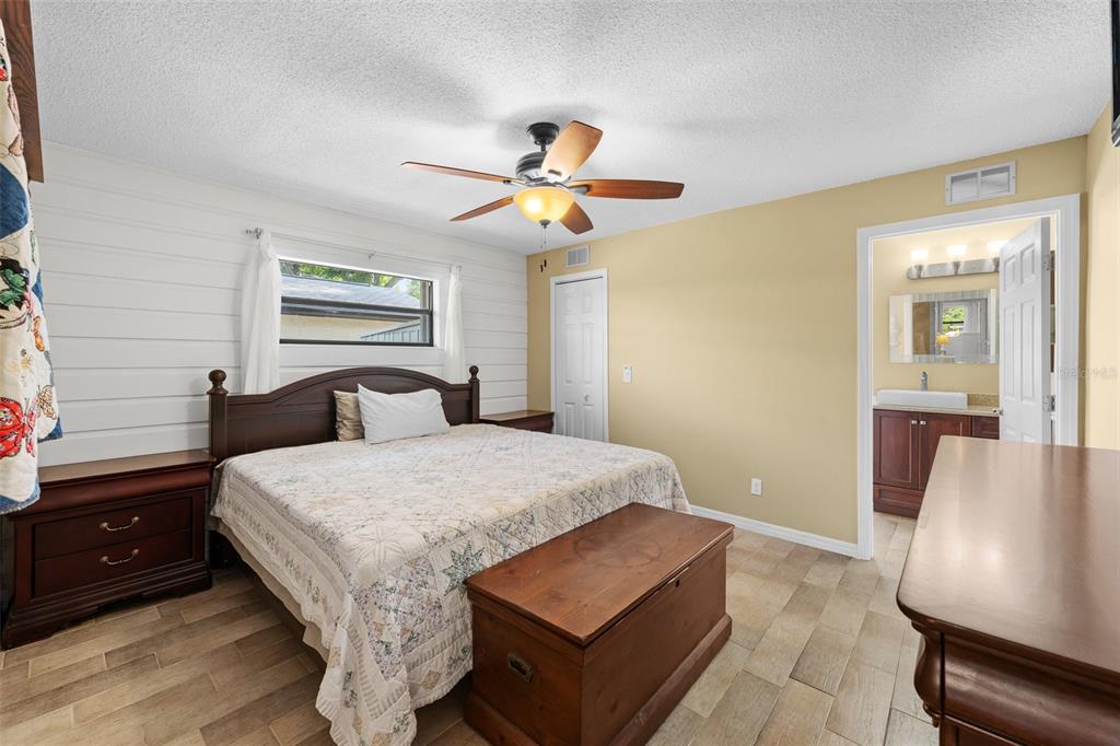 140 Valley Circle Brandon, FL 33510 - Photo 32 of 48 a bedroom with a bed and wooden floor