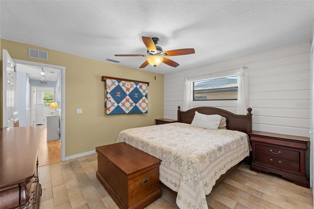 140 Valley Circle Brandon, FL 33510 - Photo 33 of 48 a bedroom with a bed and a chandelier