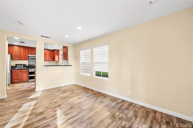 a view of a kitchen with wooden floor and a window