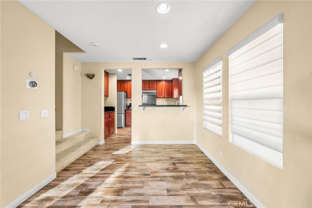 43 Three Vines Court Ladera Ranch, CA 92694 - Photo 16 of 42 a view of a kitchen with wooden floor and a window