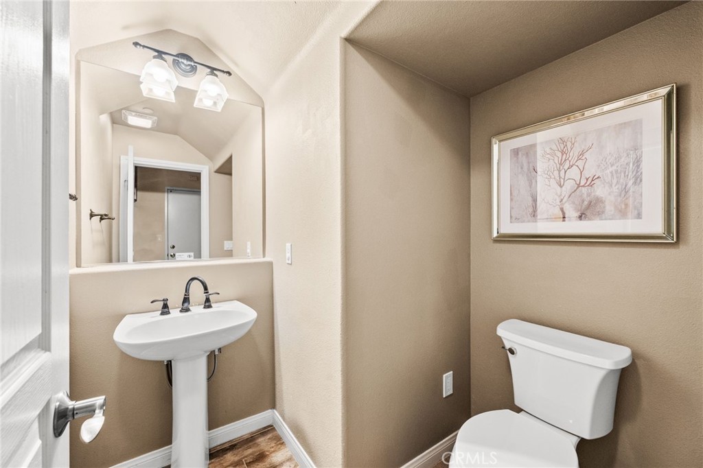43 Three Vines Court Ladera Ranch, CA 92694 - Photo 18 of 42 a bathroom with a toilet sink and mirror