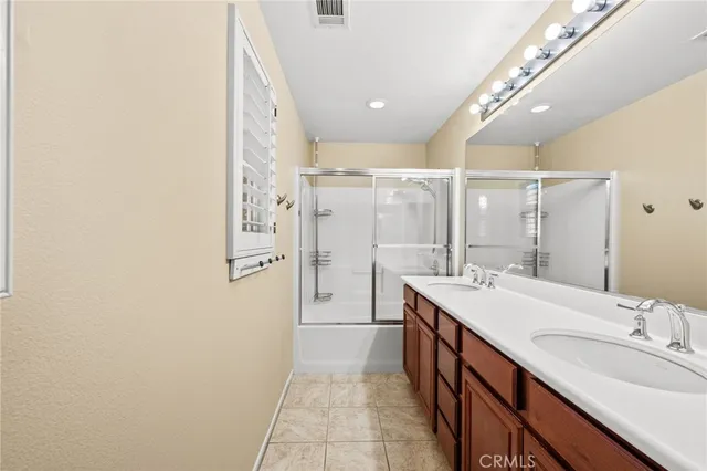 a bathroom with a sink double vanity and a mirror