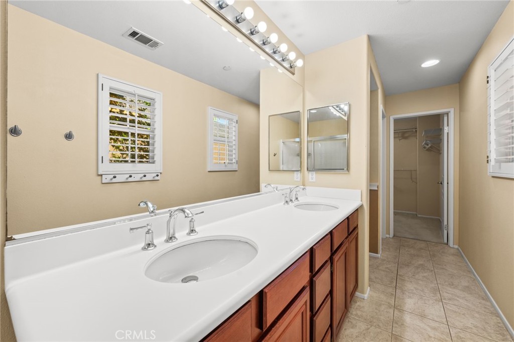 43 Three Vines Court Ladera Ranch, CA 92694 - Photo 26 of 42 a bathroom with a sink double vanity and a mirror