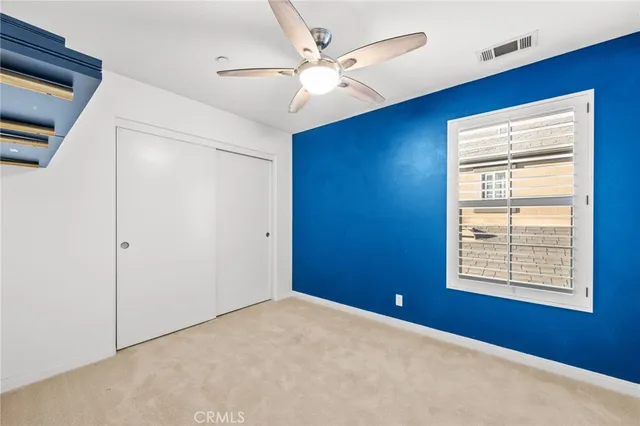 a view of a room with a ceiling fan and a bathroom