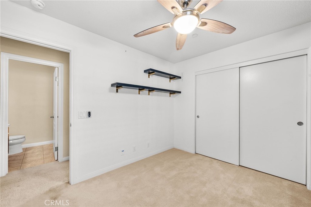 43 Three Vines Court Ladera Ranch, CA 92694 - Photo 31 of 42 a view of a room with a ceiling fan and a bathroom