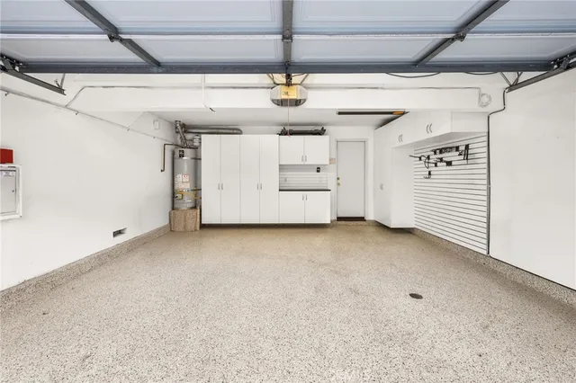 a view of a back yard of the building and cars parked