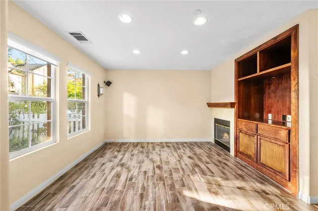a view of a kitchen with wooden floor and a refrigerator