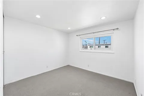an empty room with a painting on the wall