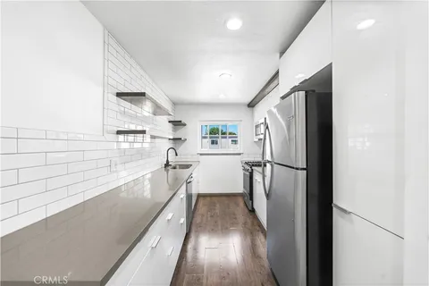 a kitchen with stainless steel appliances a refrigerator and a stove