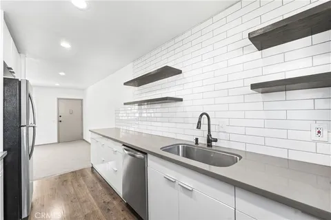 a kitchen with a sink and cabinets