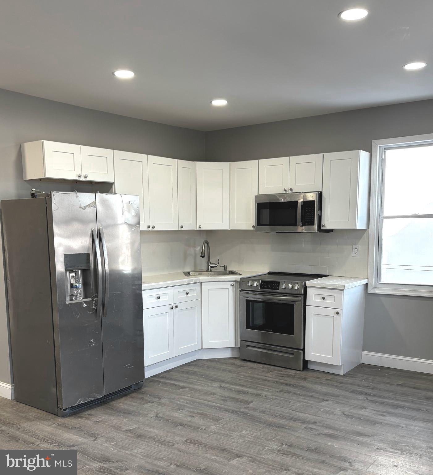 11890 Bustleton Avenue Philadelphia, PA 19116 - Photo 1 of 12 a kitchen with stainless steel appliances granite countertop a stove a sink and a refrigerator