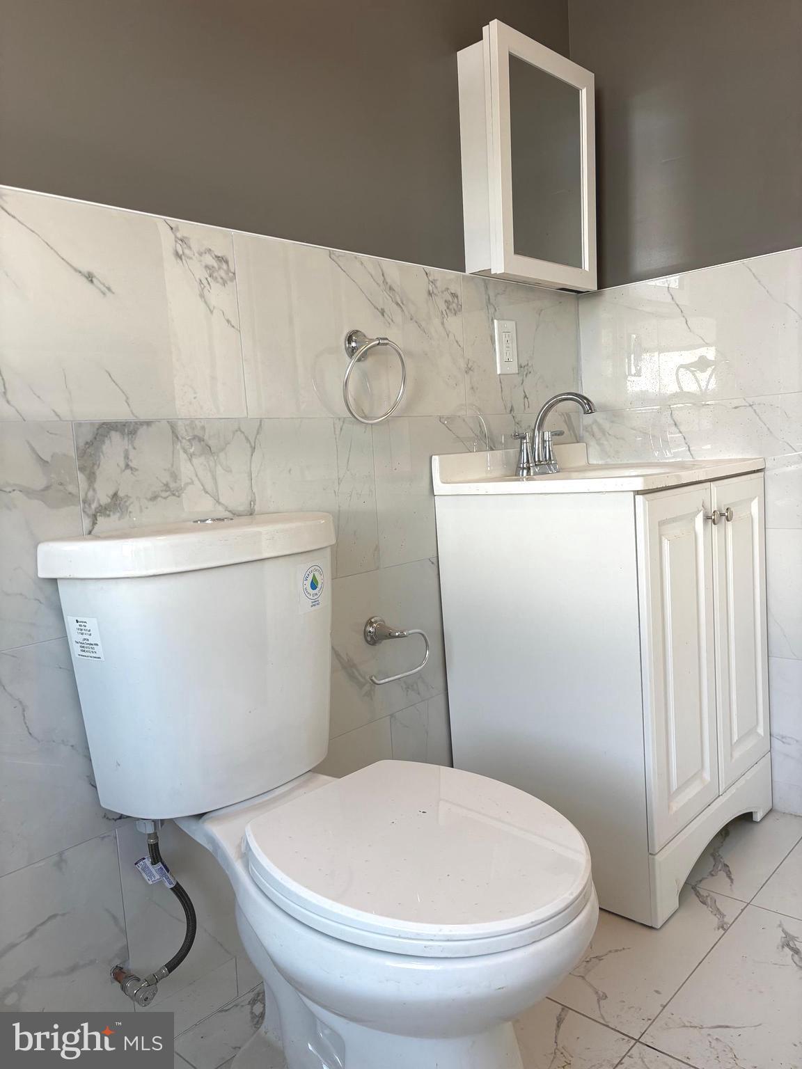 11890 Bustleton Avenue Philadelphia, PA 19116 - Photo 8 of 12 a bathroom with a sink a toilet and mirror