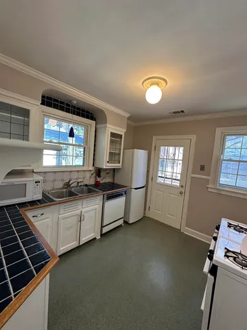 a kitchen with sink cabinets and window