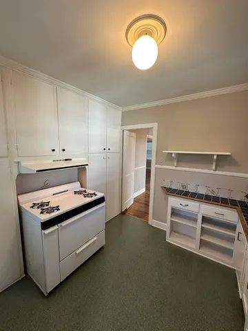 a stove top oven sitting inside of a kitchen