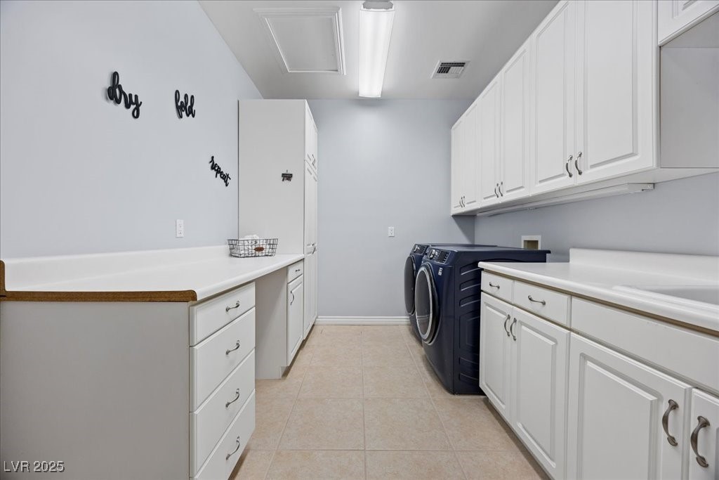 640 Quail Covey Road Henderson, NV 89002 - Photo 27 of 75 Large Laundry Room featuring cabinet space, washing machine and clothes dryer, and light tile patterned floors