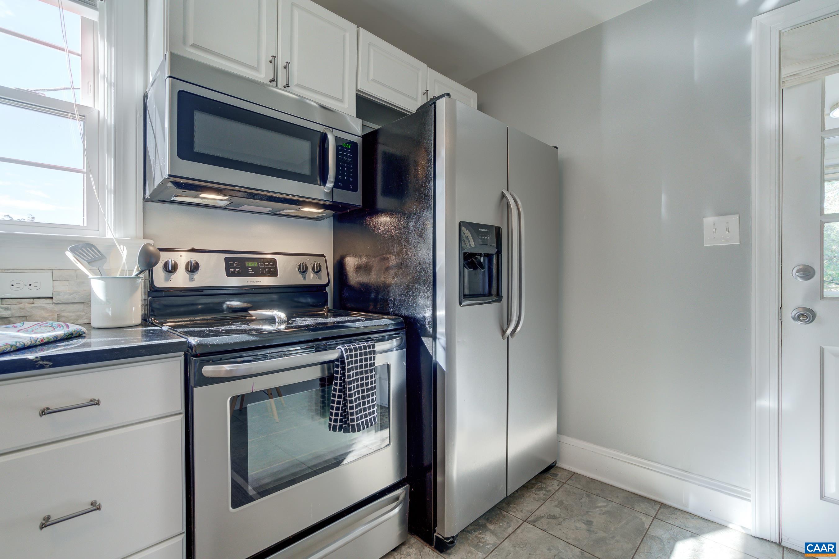 2974 Milton Road Charlottesville, VA 22902 - Photo 18 of 50 a kitchen with stainless steel appliances granite countertop a stove microwave and refrigerator
