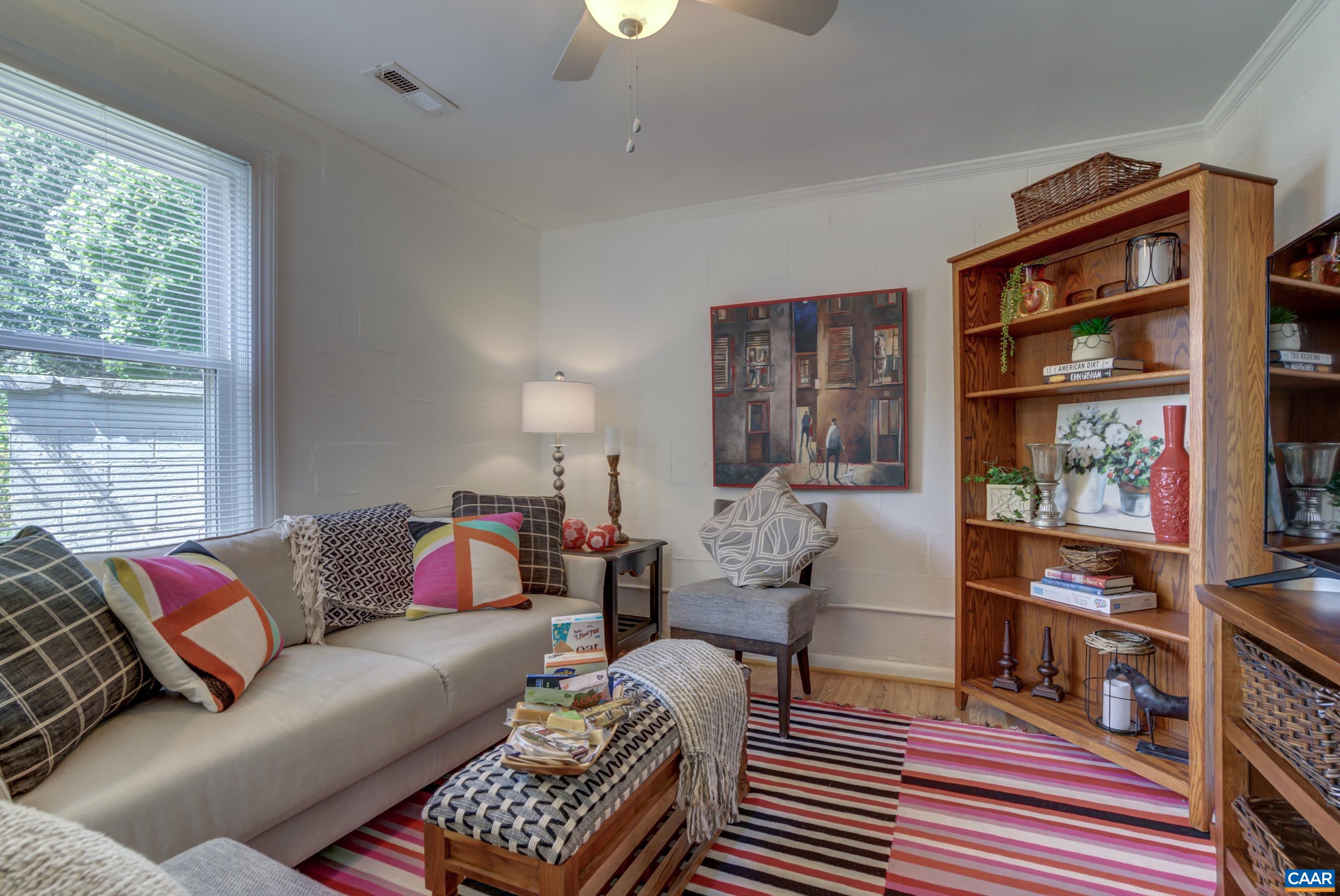 2974 Milton Road Charlottesville, VA 22902 - Photo 28 of 50 a living room with furniture a rug and a book shelf
