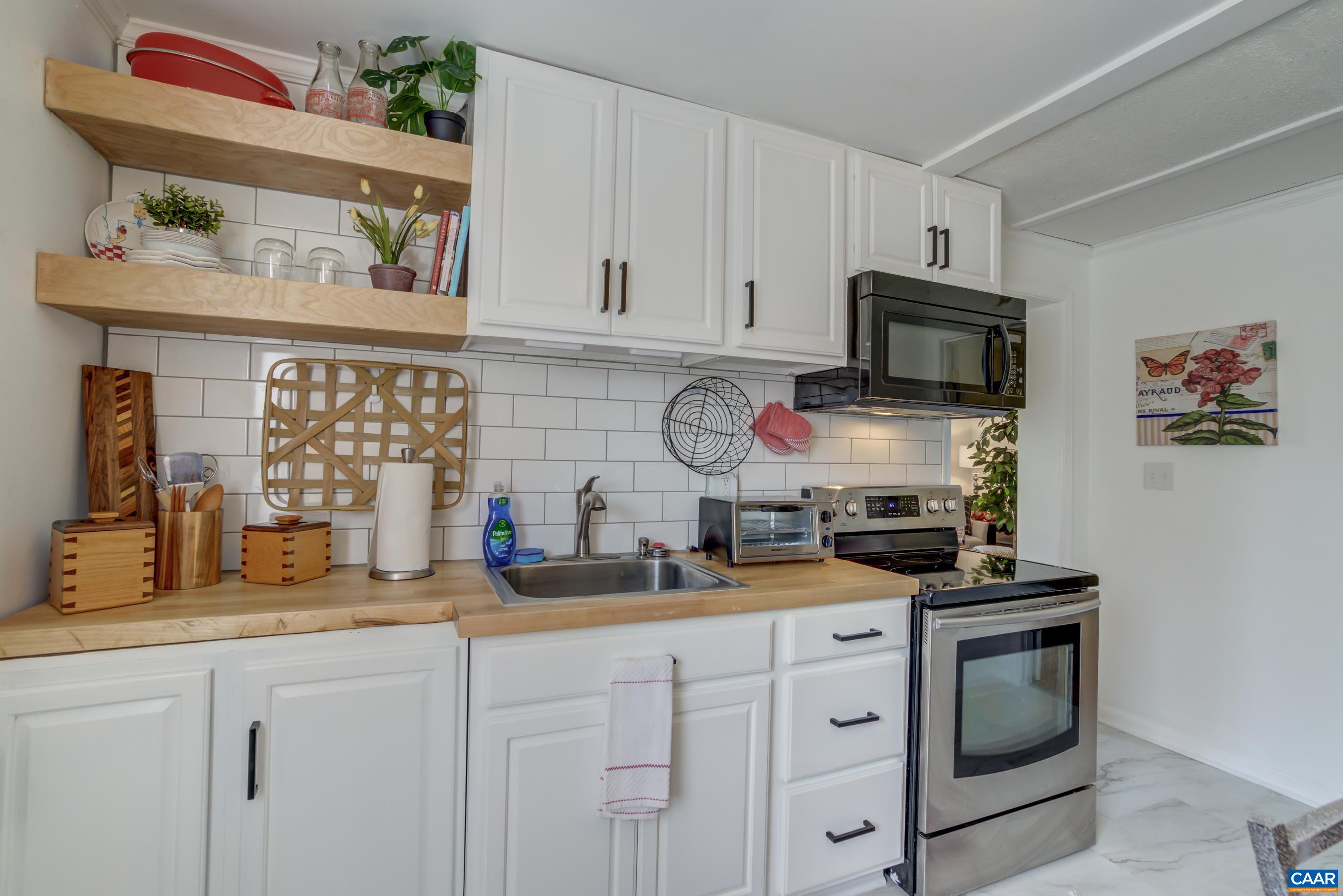 2974 Milton Road Charlottesville, VA 22902 - Photo 38 of 50 a kitchen with stainless steel appliances a stove microwave and cabinets