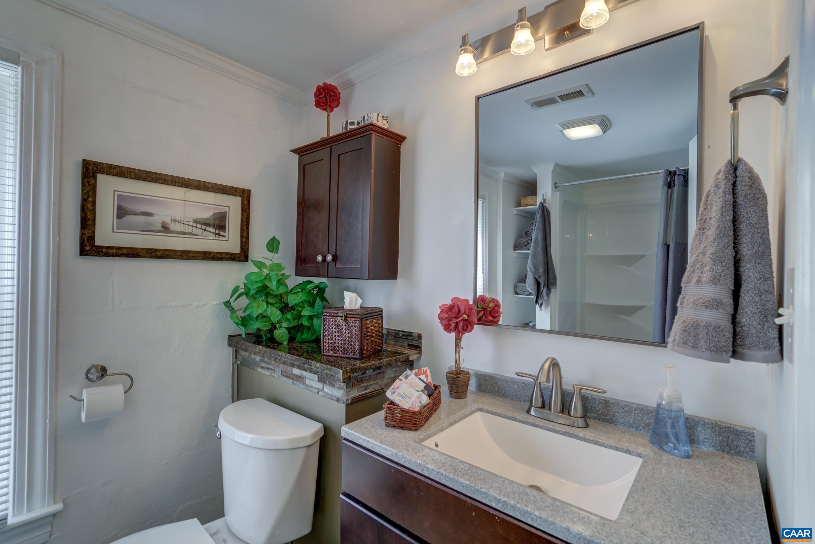2974 Milton Road Charlottesville, VA 22902 - Photo 39 of 50 a bathroom with a granite countertop sink mirror and toilet