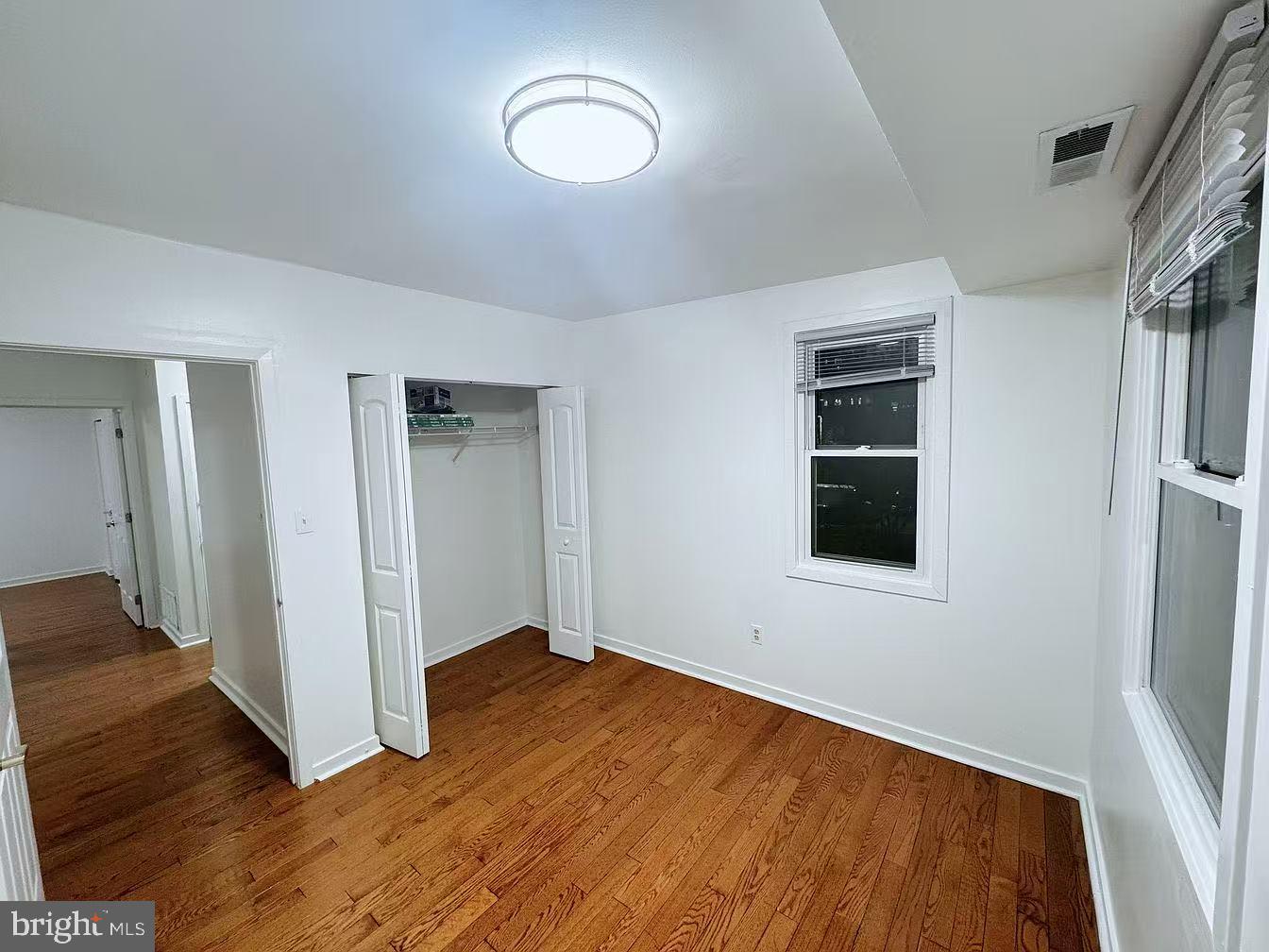 304 North 8th Street Philadelphia, PA 19123 - Photo 12 of 16 a view of an empty room with wooden floor and a window