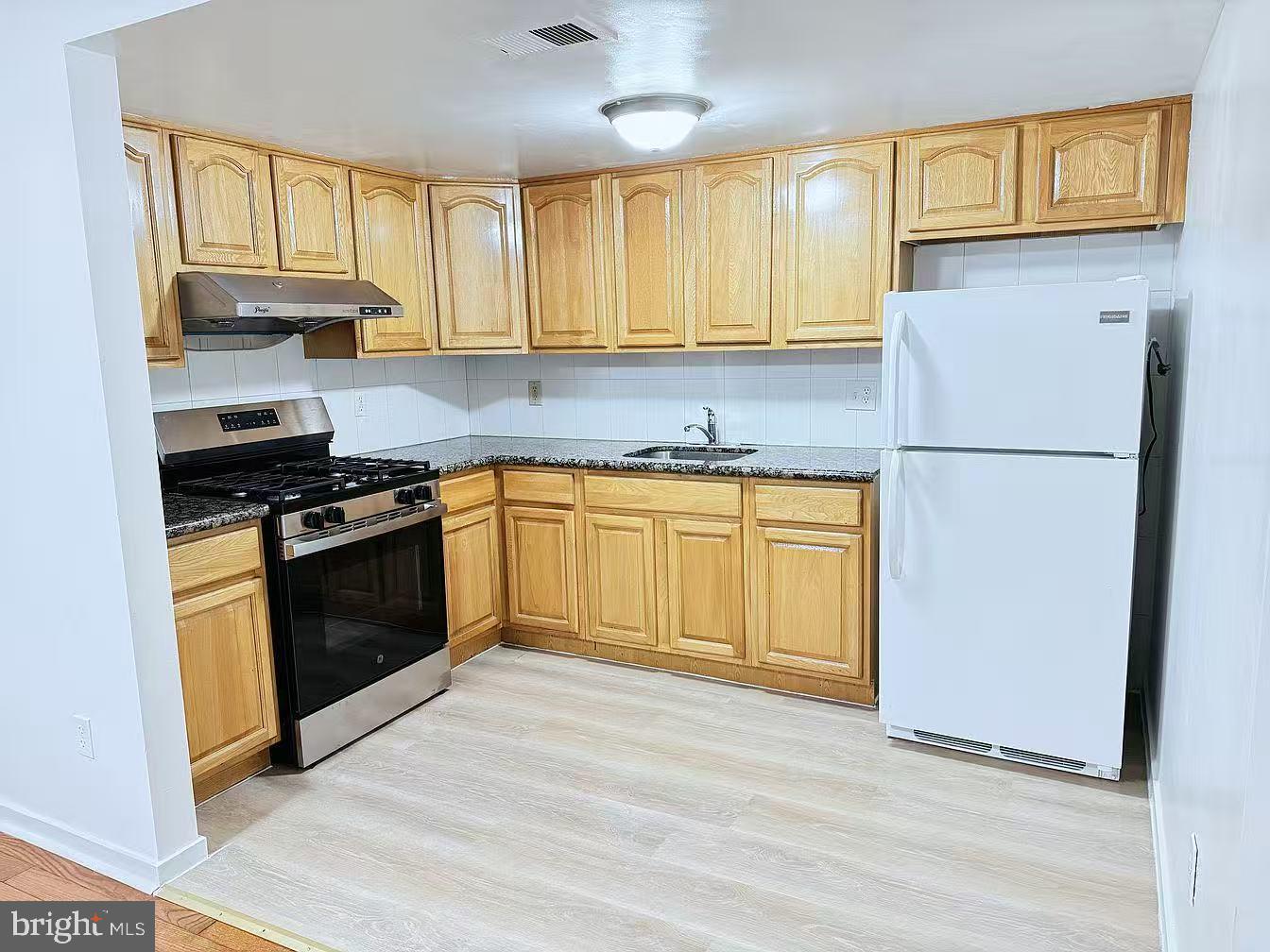 304 North 8th Street Philadelphia, PA 19123 - Photo 8 of 16 a kitchen with a sink stove and refrigerator
