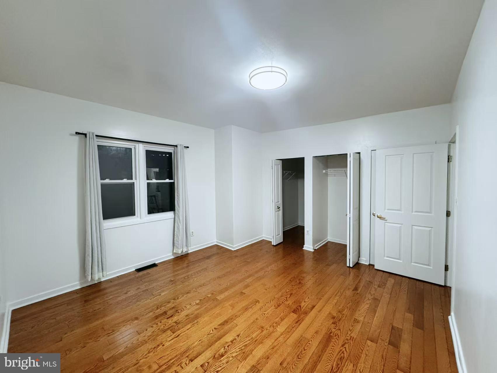 304 North 8th Street Philadelphia, PA 19123 - Photo 10 of 16 a view of an empty room with wooden floor and kitchen