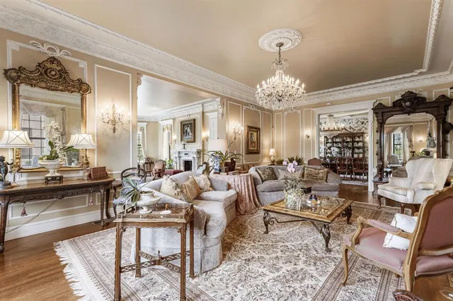 a living room with lots of furniture and chandelier