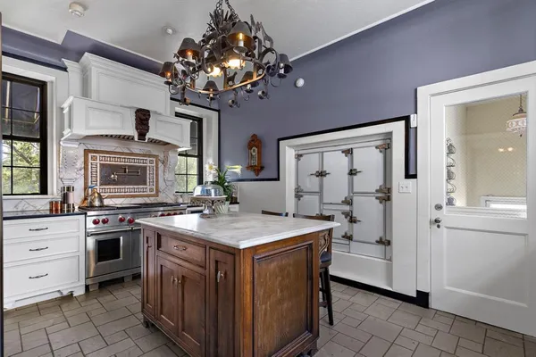 a kitchen that has a stove and a table in it