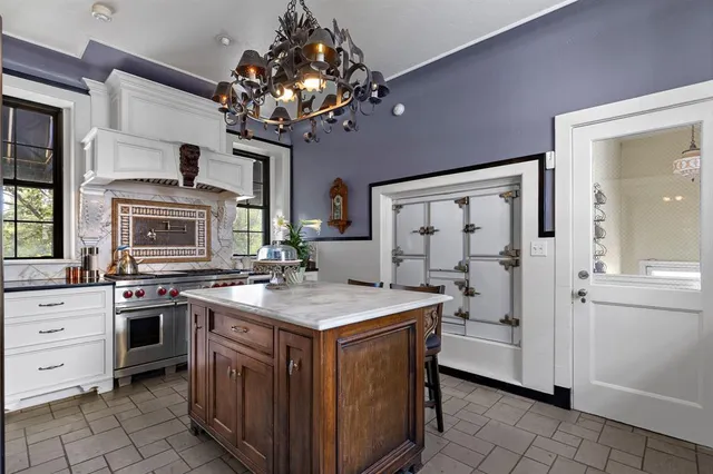 a kitchen that has a stove and a table in it