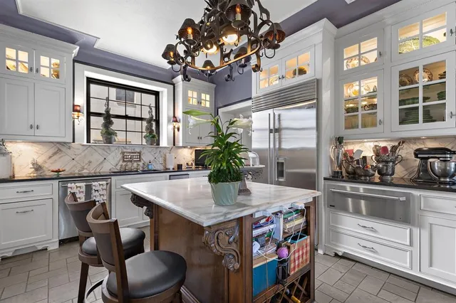 a kitchen with stainless steel appliances granite countertop a sink and cabinets