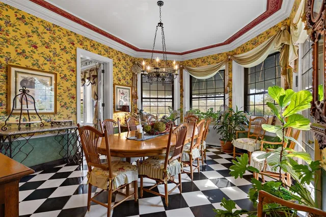 a view of a dining room with furniture and chandelier