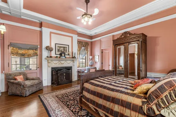 a bedroom with a bed couch and a fireplace