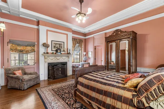 a bedroom with a bed couch and a fireplace