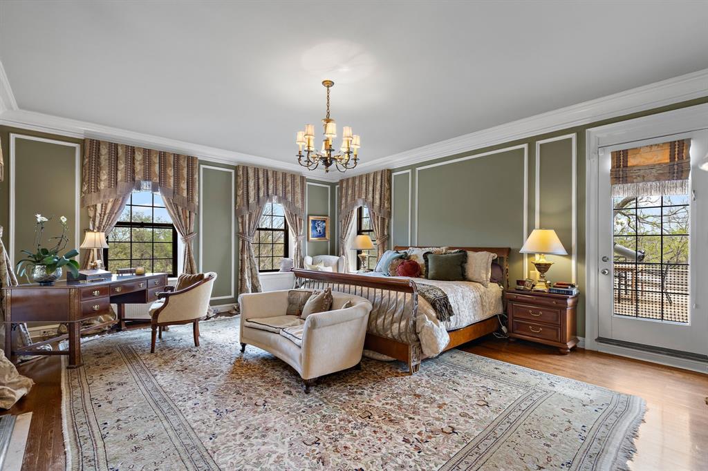 3100 Hamilton Boulevard Wichita Falls, TX 76308 - Photo 26 of 40 a spacious bedroom with a bed and a chandelier