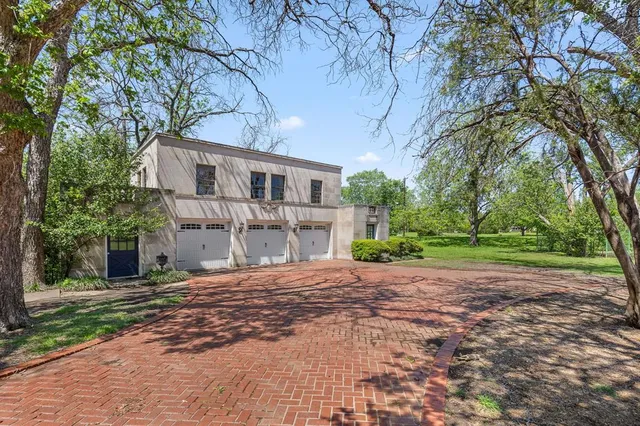 a front view of a house with a yard and a garage