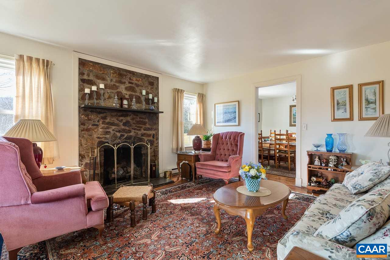815 Foothills Road Stanardsville, VA 22973 - Photo 6 of 15 a living room with furniture a window and a fireplace