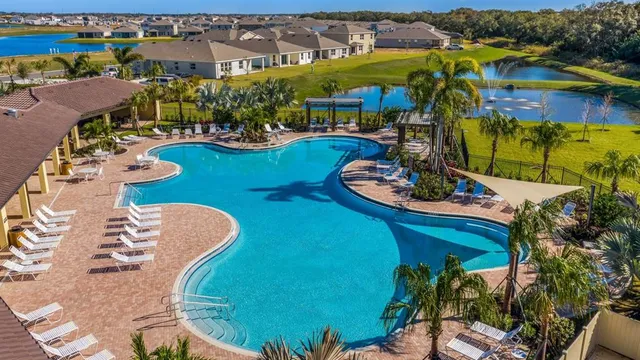 an aerial view of a house with swimming pool patio and outdoor seating