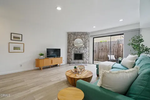 a living room with furniture and a fireplace