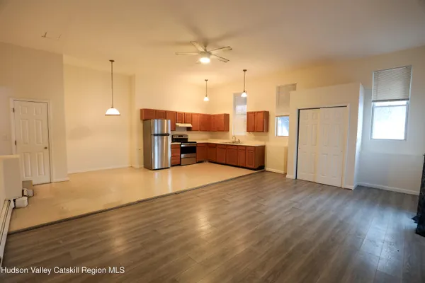 a view of a kitchen with a sink and a refrigerator