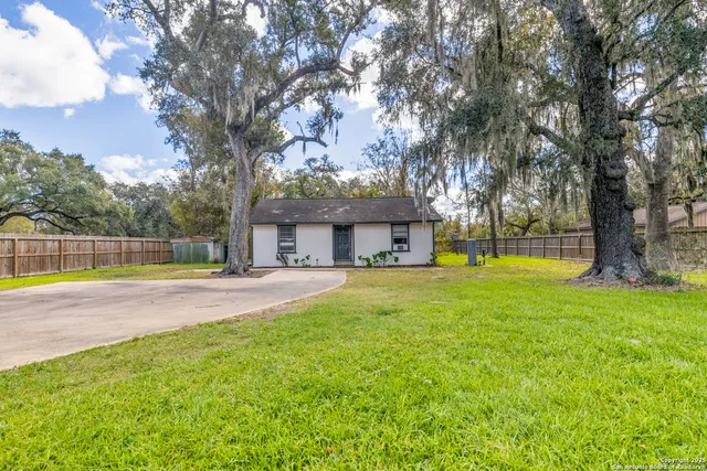 a view of a house with swimming pool and a yard