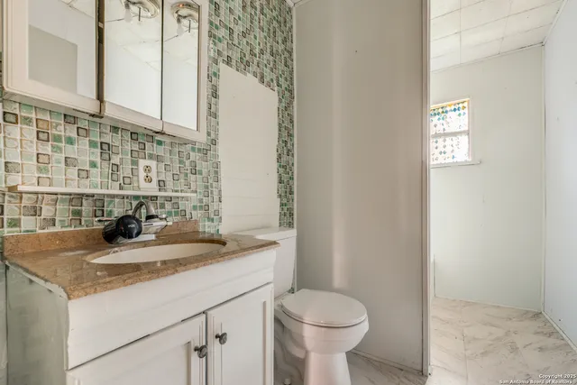 a bathroom with a sink and toilet
